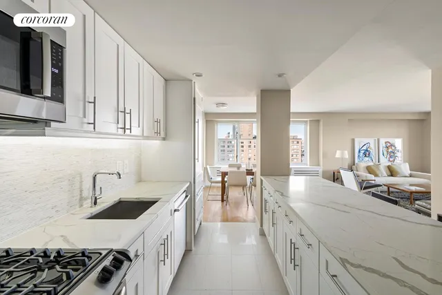 a kitchen with counter top space stove sink and cabinets