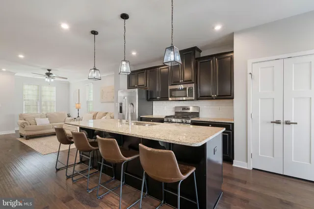 a dining room with furniture and wooden floor