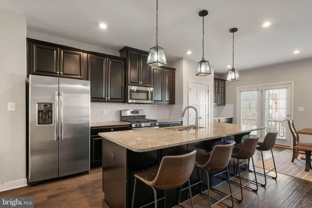 a kitchen with granite countertop stainless steel appliances and wooden cabinets