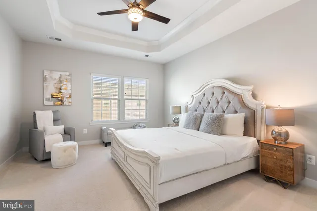 a bathroom with a granite countertop bathtub a sink and a mirror