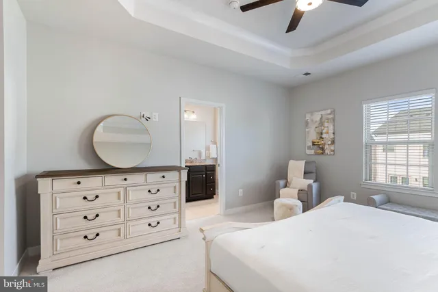 a bathroom with a granite countertop sink toilet and mirror