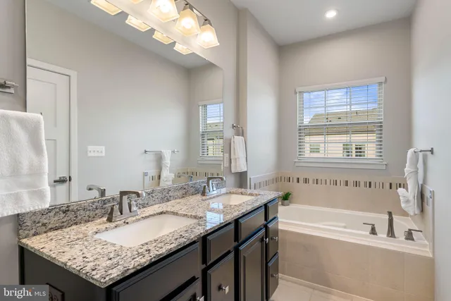 a utility room with stainless steel appliances wooden cabinets and a stove top oven