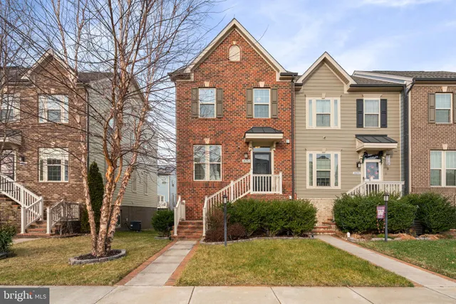 a view of a brick house with a yard
