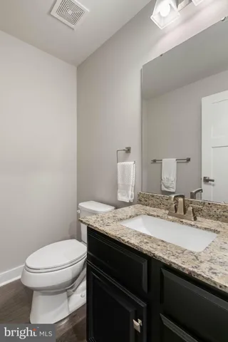 a kitchen with a stove a table and chairs in it