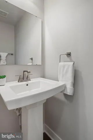 a living room with furniture a fireplace and paintings on the wall