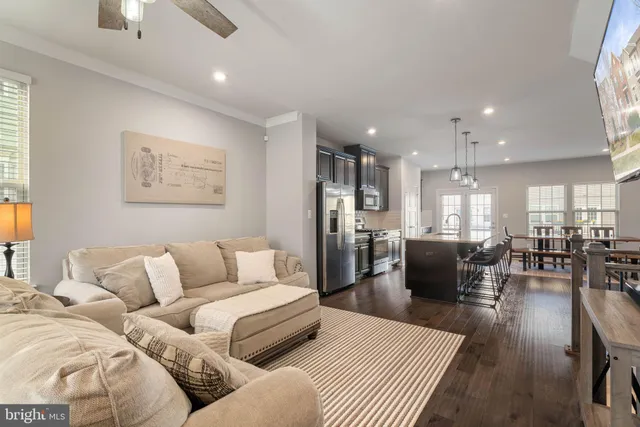 a kitchen with stainless steel appliances granite countertop a sink a stove and a wooden floors