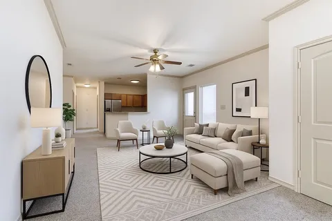 a living room with furniture a mirror and a chandelier