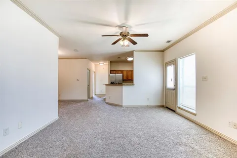 an empty room with a empty space and windows