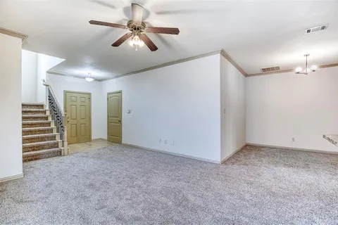 a view of an empty room with a ceiling fan