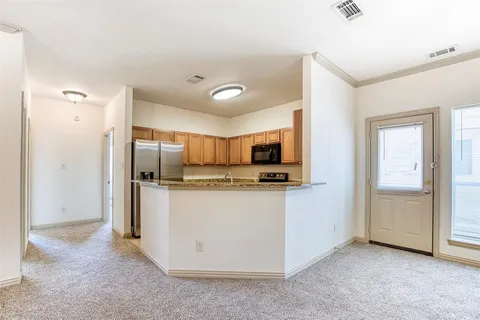 a kitchen with stainless steel appliances a refrigerator and a stove