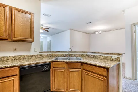 a view of a kitchen counter top space cabinets and stainless steel appliances