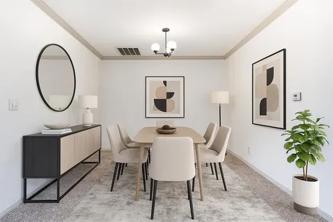 a dining room with furniture and a mirror