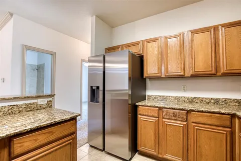 a kitchen with stainless steel appliances granite countertop a refrigerator and cabinets