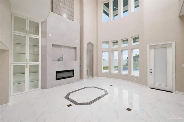 a living room with furniture a fireplace and a large window