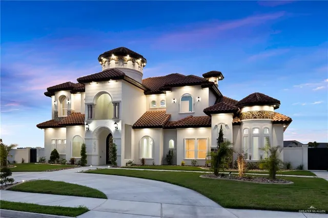 a view of a building with a yard and table in front of it