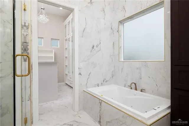 a bathroom with a tub sink and mirror