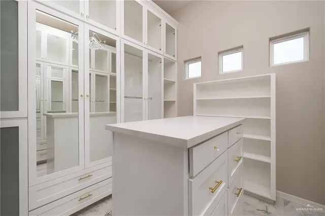 a view of walk in closet with empty racks