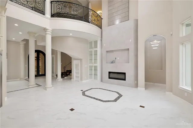 a view of a livingroom with a fireplace and window