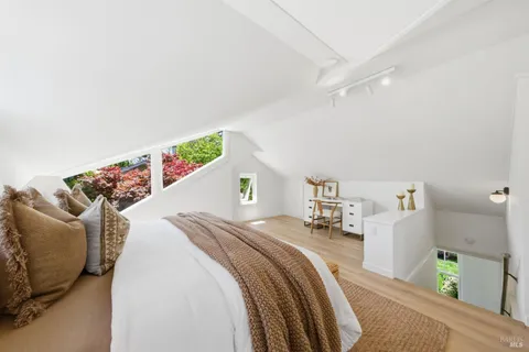 a bedroom with a bed and a potted plant
