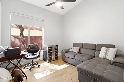 a bedroom with a bed and a large window