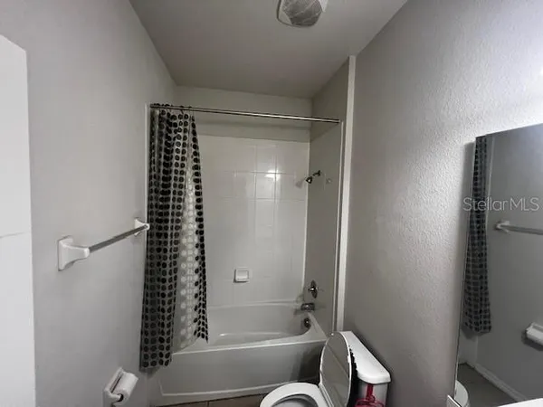 a bathroom with a bathtub and shower