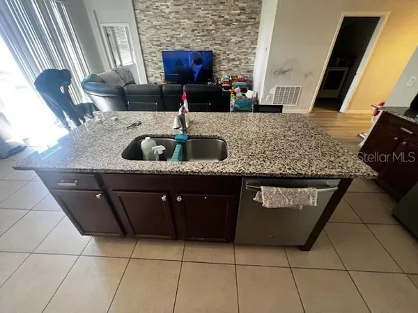 a kitchen with a sink a counter top space and appliances