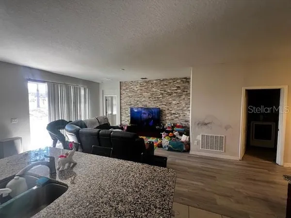 a living room with furniture and a flat screen tv