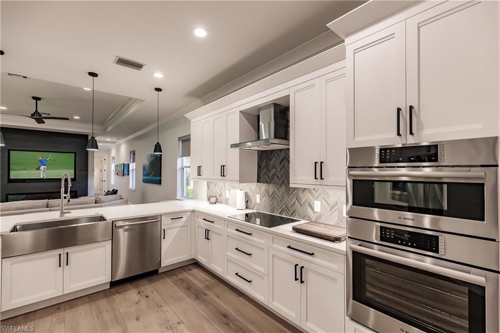 a kitchen with stainless steel appliances white cabinets and a sink