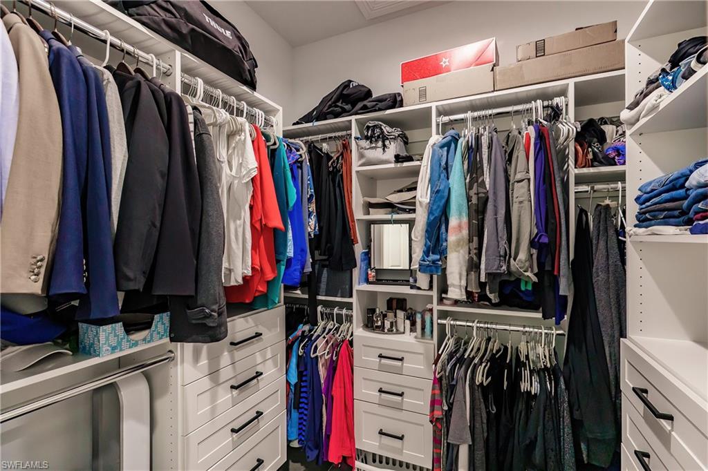 20199 Markward Crossing Estero, FL 33928 - Photo 16 of 45 a view of walk in closet with clothes and shoes