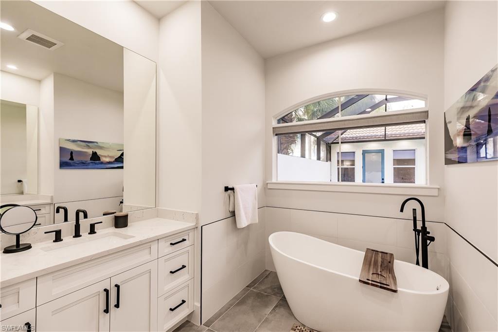 20199 Markward Crossing Estero, FL 33928 - Photo 20 of 45 a bathroom with a sink and a mirror