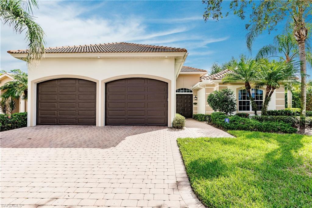 20199 Markward Crossing Estero, FL 33928 - Photo 2 of 45 a front view of a house with garden