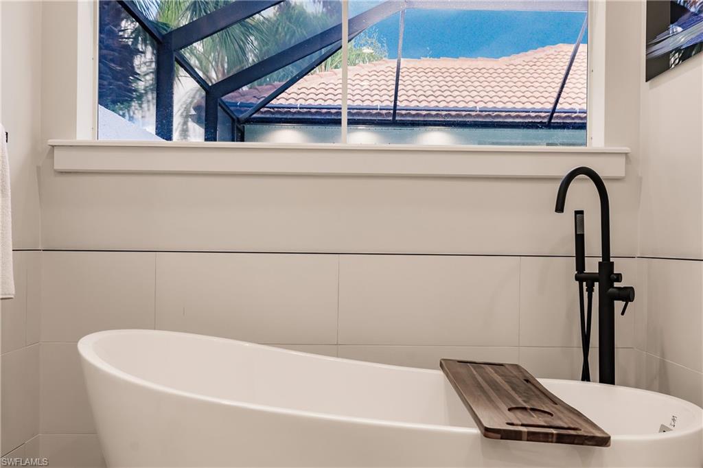 20199 Markward Crossing Estero, FL 33928 - Photo 21 of 45 a bathroom with a bathtub