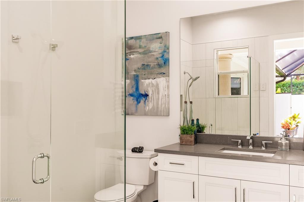 20199 Markward Crossing Estero, FL 33928 - Photo 25 of 45 a bathroom with a granite countertop sink a mirror and a shower