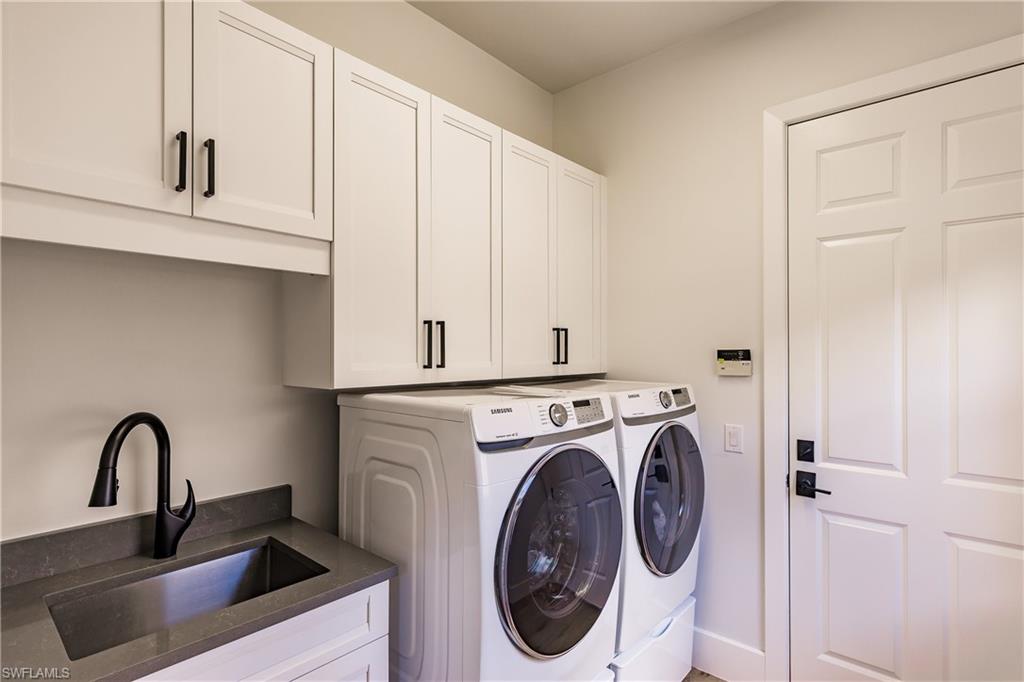 20199 Markward Crossing Estero, FL 33928 - Photo 27 of 45 a bathroom with a sink and a washer dryer