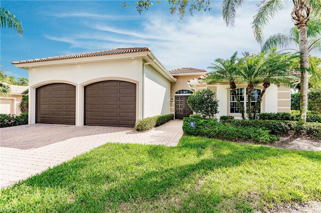 20199 Markward Crossing Estero, FL 33928 - Photo 3 of 45 a front view of a house with garden