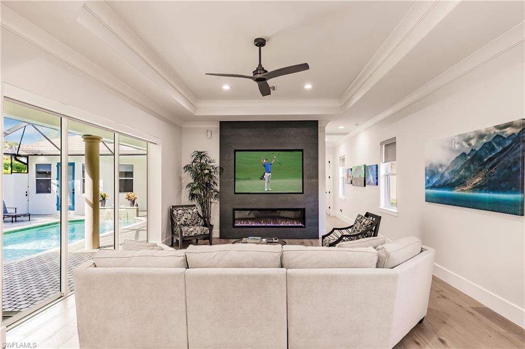 20199 Markward Crossing Estero, FL 33928 - Photo 5 of 45 a living room with furniture and a flat screen tv