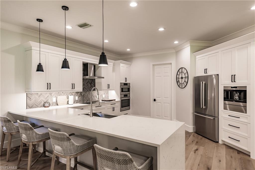 20199 Markward Crossing Estero, FL 33928 - Photo 8 of 45 a kitchen with refrigerator and chairs
