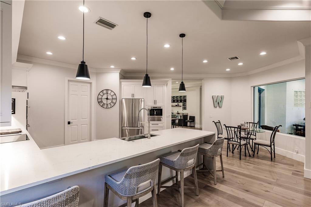 20199 Markward Crossing Estero, FL 33928 - Photo 10 of 45 a large kitchen with a table and chairs