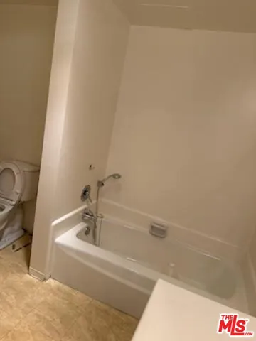 a white bath tub sitting next to a white sink