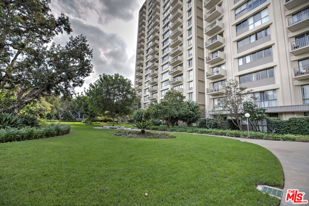 2160 Century Park East, Unit 503 Los Angeles, CA 90067 - Photo 17 of 22 a view of a big building with a big yard and large trees