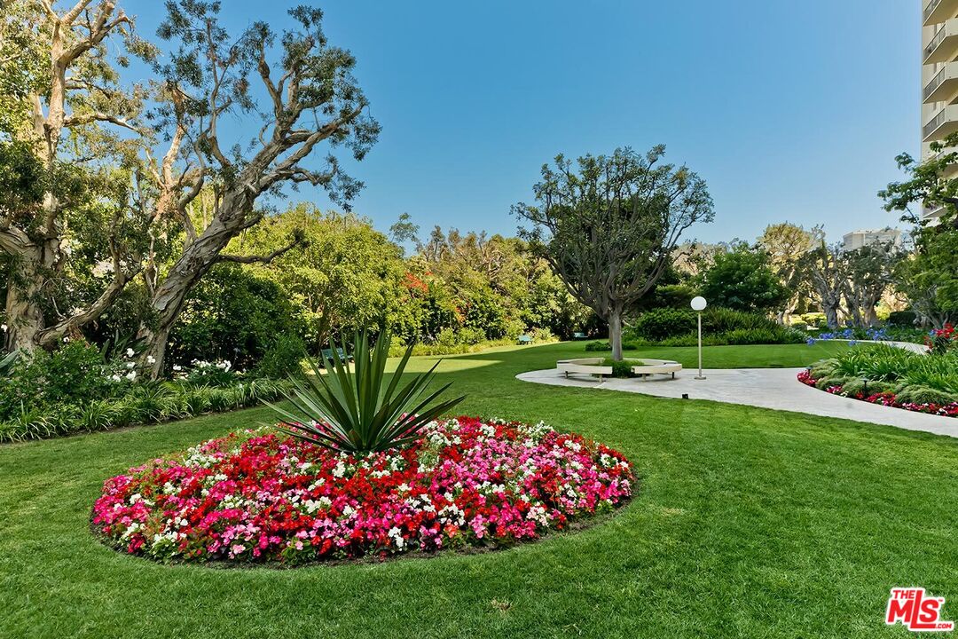 2160 Century Park East, Unit 503 Los Angeles, CA 90067 - Photo 19 of 22 a view of a garden with flowers and wooden fence