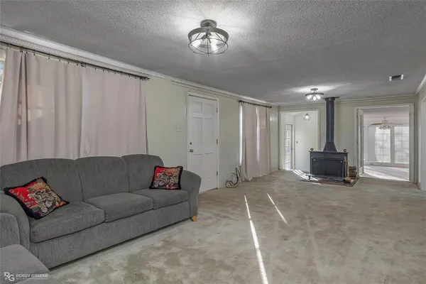 a living room with furniture and a ceiling fan