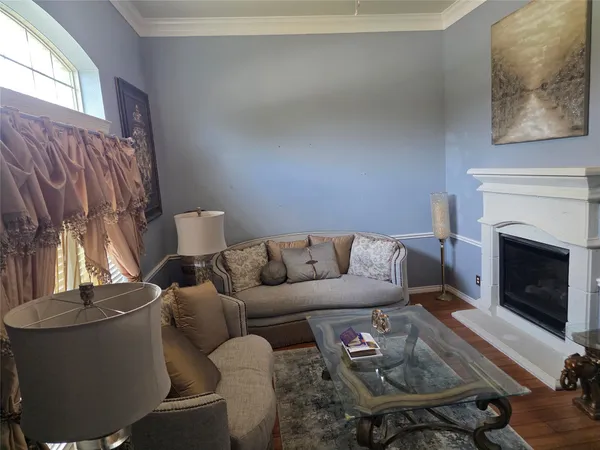 a living room with furniture a fireplace and a window