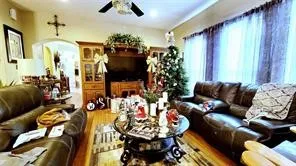 a living room with furniture and a chandelier