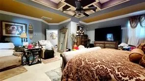 a bed room with a bed and a television