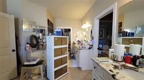 a view of walk in closet and bedroom