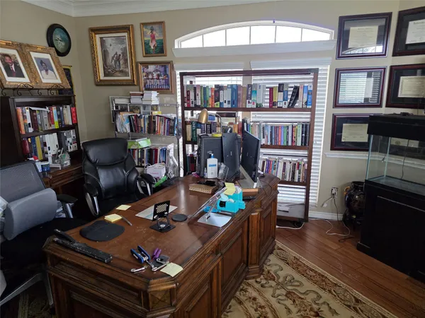 a living room with furniture and a bookshelf