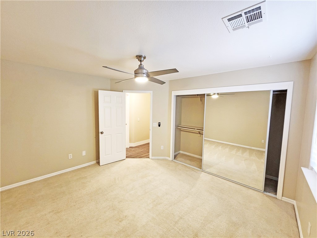 4591 Stoneham Street Pahrump, NV 89061 - Photo 36 of 42 An inviting bedroom with plush carpeting and a large mirrored closet offers comfortable living.
