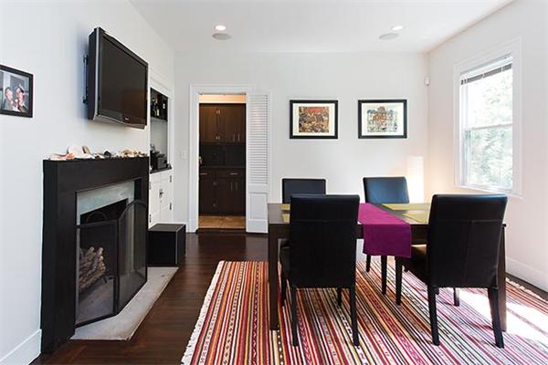 369 Dudley Road Newton, MA 02459 - Photo 2 of 9 a living room with furniture a flat screen tv and a fireplace