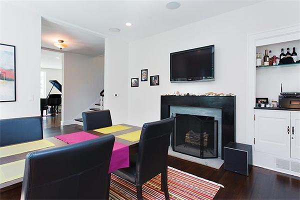 369 Dudley Road Newton, MA 02459 - Photo 3 of 9 a living room with furniture a flat screen tv and a fireplace